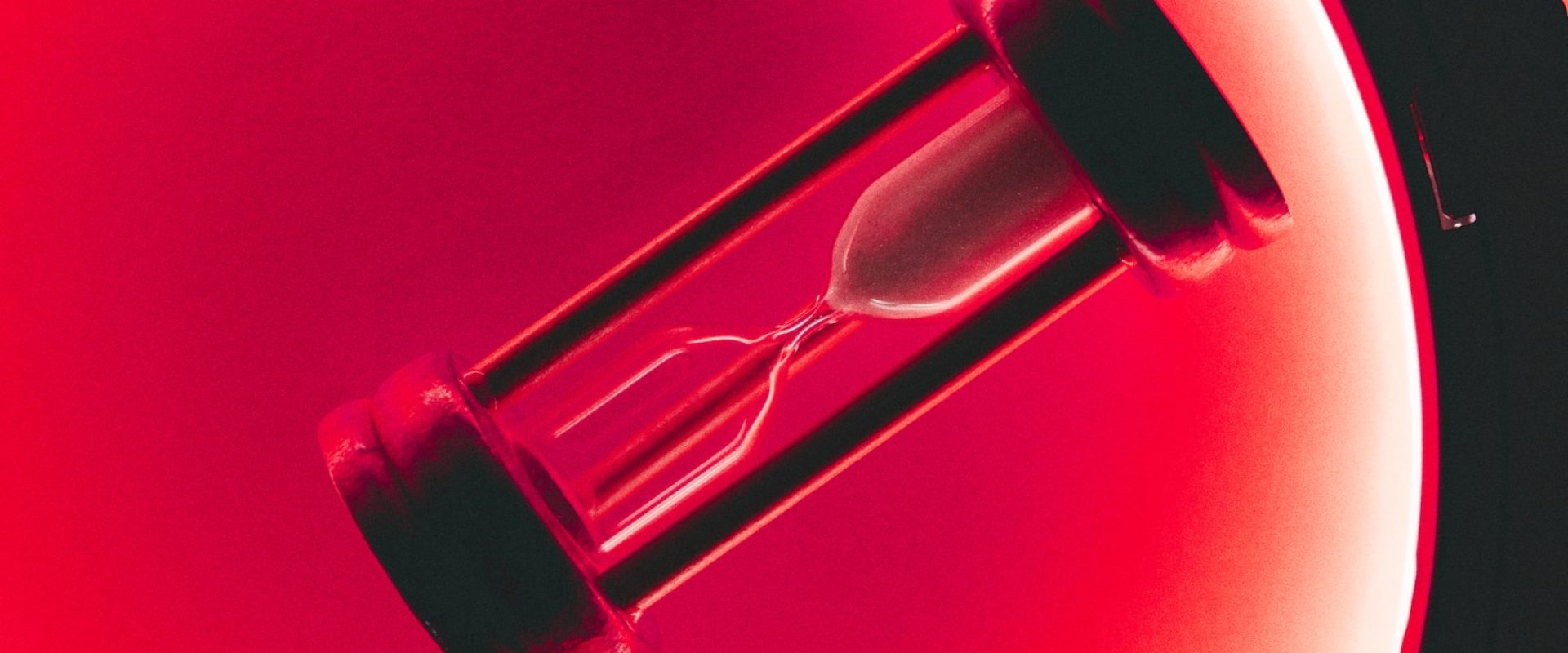 clear hour glass with red background